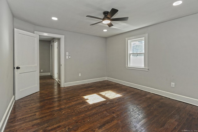 unfurnished room with ceiling fan and dark hardwood / wood-style floors