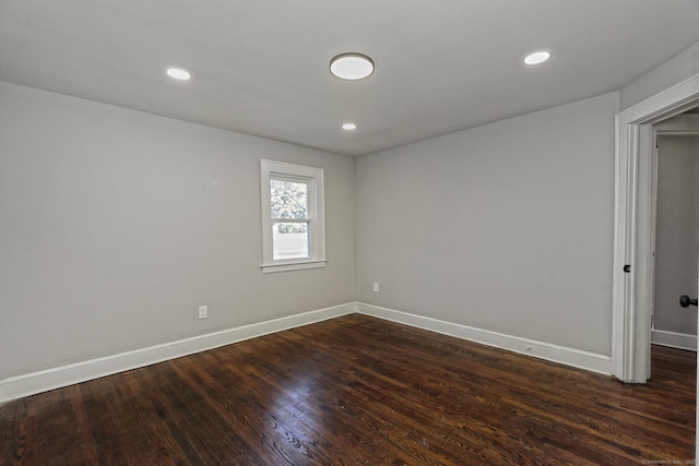 unfurnished room featuring dark wood-type flooring