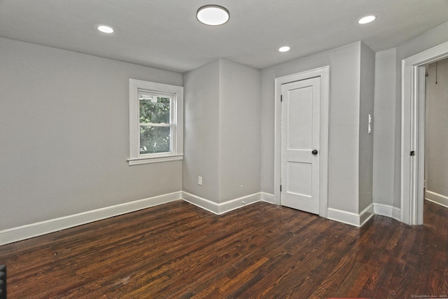 empty room featuring dark hardwood / wood-style flooring