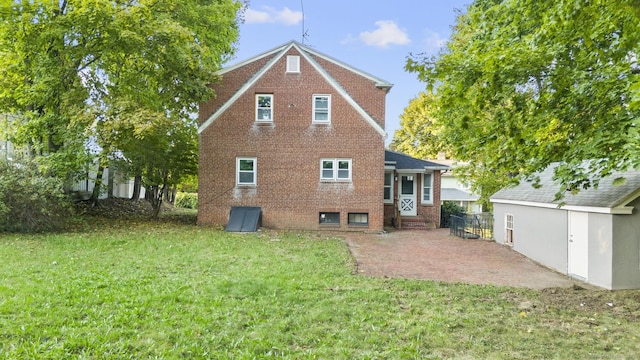 rear view of house featuring a patio area and a yard