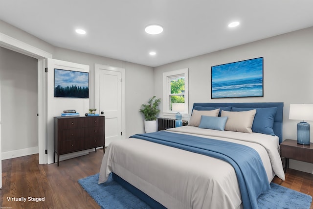 bedroom featuring radiator and dark hardwood / wood-style flooring