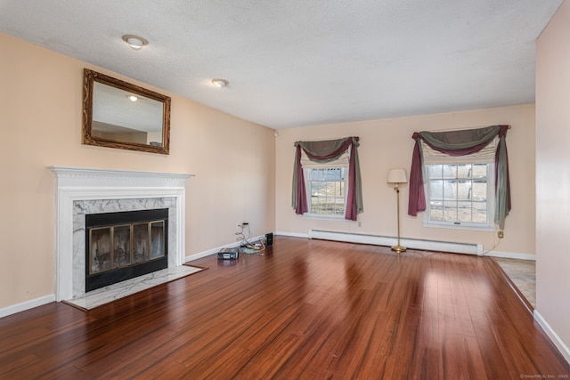 16 Snow Rdg S, Middletown, CT 06457 - unfurnished living room with baseboards, a baseboard radiator, a fireplace, and wood finished floors