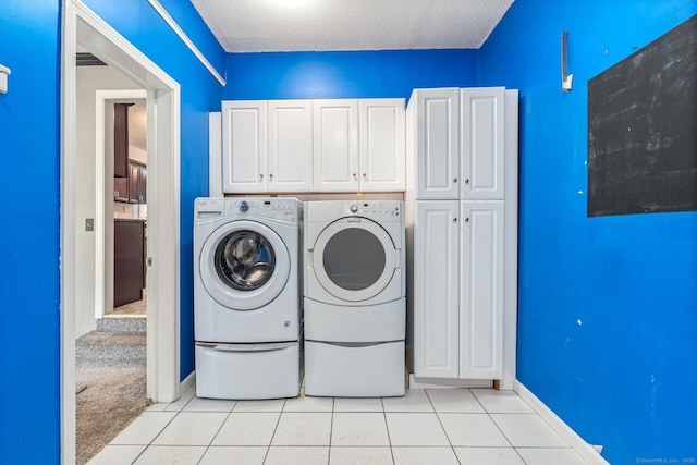 16 Snow Rdg S, Middletown, CT 06457 - laundry area with a textured ceiling, cabinet space, baseboards, separate washer and dryer, and light tile patterned flooring