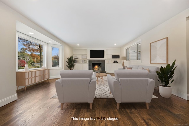 living room featuring built in features and dark wood-type flooring