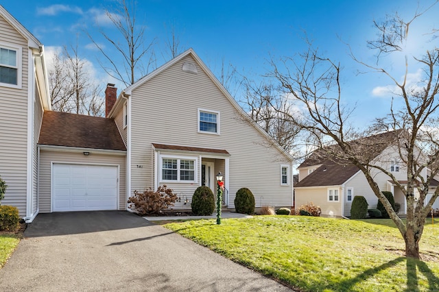 view of front of house with a front lawn and a garage