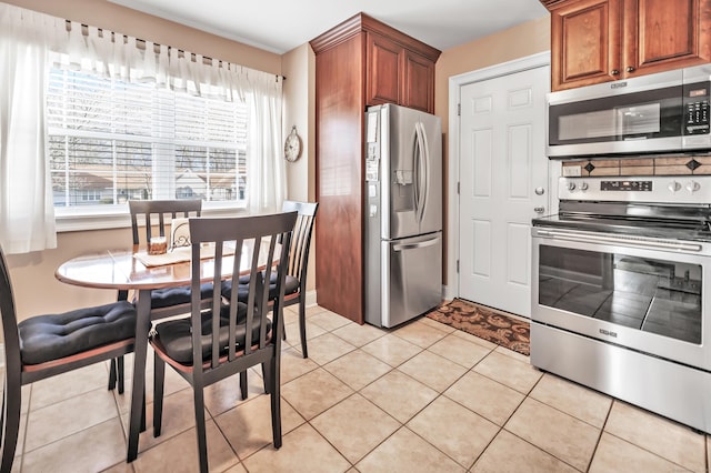 kitchen featuring light tile patterned flooring and stainless steel appliances