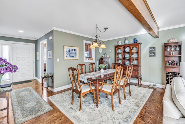 dining area featuring hardwood / wood-style flooring, crown molding, beamed ceiling, and a chandelier