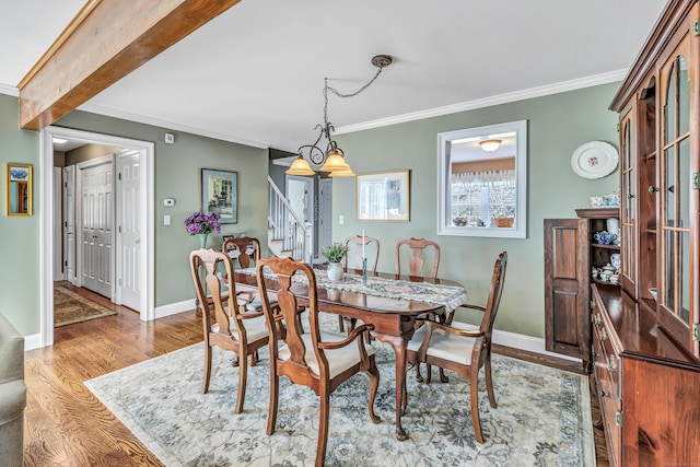 dining room featuring a chandelier, wood-type flooring, and ornamental molding