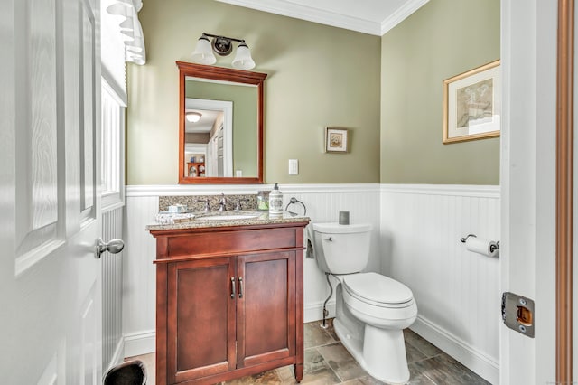 bathroom with vanity, toilet, and crown molding