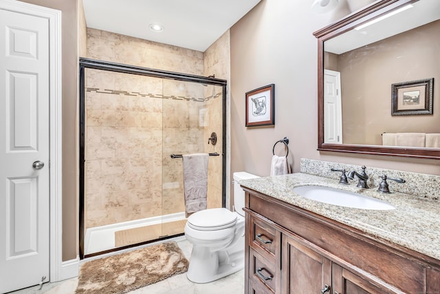 bathroom featuring vanity, toilet, and an enclosed shower