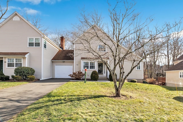 front facade with a garage and a front lawn