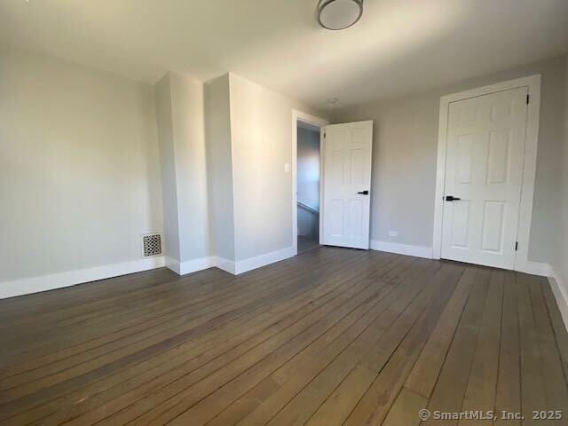 empty room featuring dark hardwood / wood-style floors