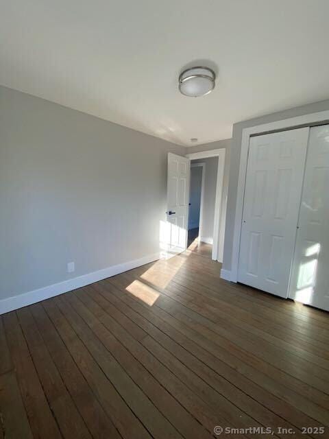 empty room featuring dark wood-type flooring