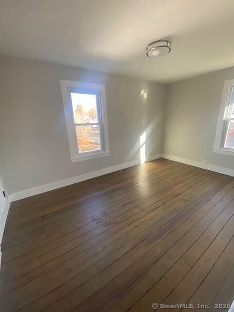 spare room with dark hardwood / wood-style floors