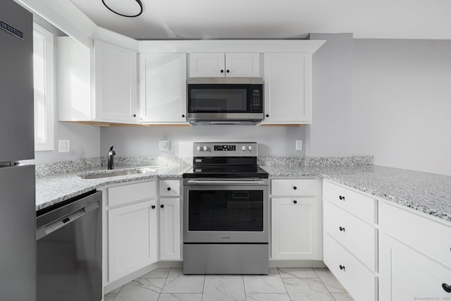 kitchen with sink, white cabinetry, and stainless steel appliances