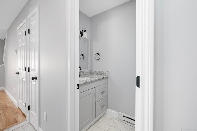 bathroom with vanity and a baseboard radiator