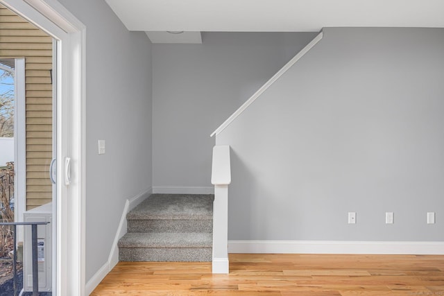 stairs with hardwood / wood-style floors