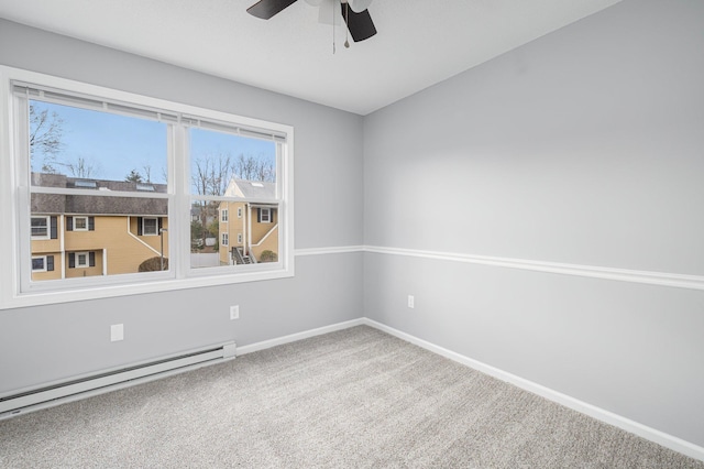 carpeted empty room with ceiling fan and a baseboard radiator