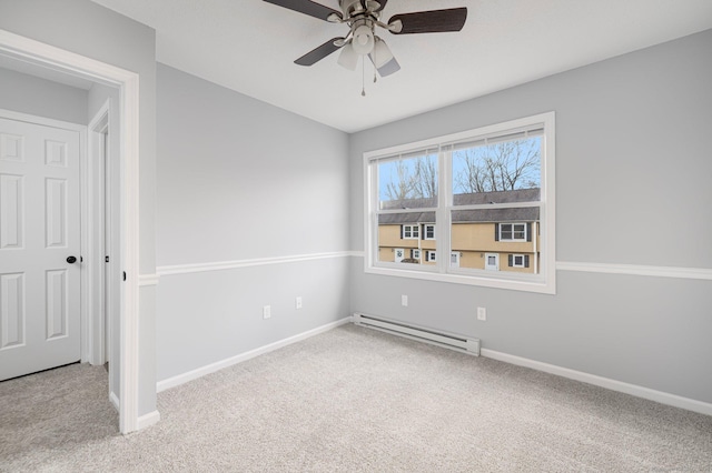 spare room with a baseboard radiator, ceiling fan, and light colored carpet