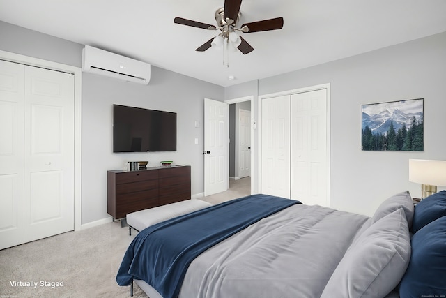 carpeted bedroom featuring ceiling fan, an AC wall unit, and multiple closets