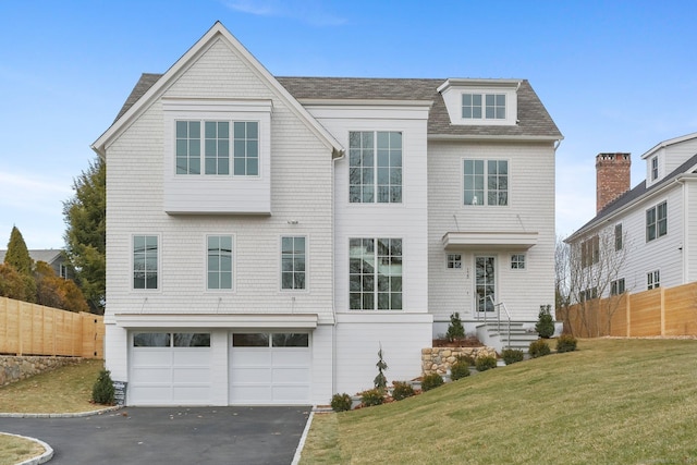 view of front facade with a garage and a front lawn