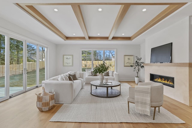 living room featuring light hardwood / wood-style floors and beam ceiling