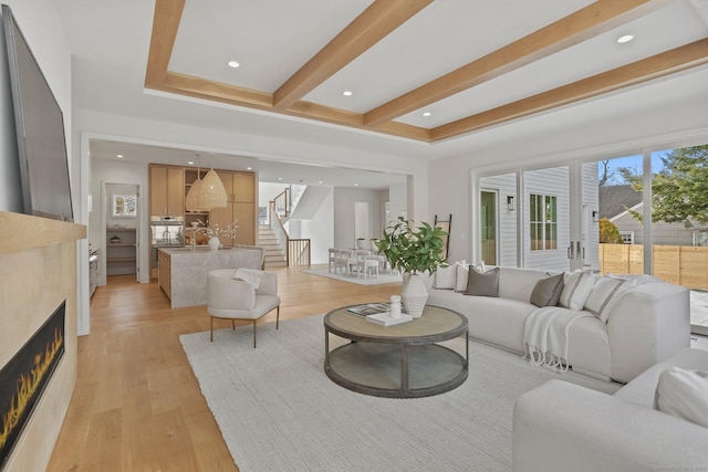 living room featuring light hardwood / wood-style floors and beam ceiling