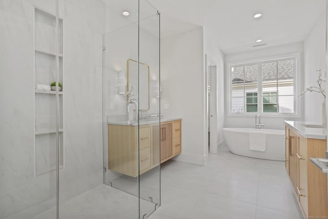 bathroom featuring vanity and shower with separate bathtub