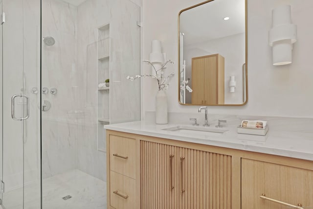 bathroom featuring vanity and a shower with shower door