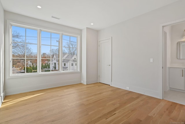 spare room featuring light hardwood / wood-style floors