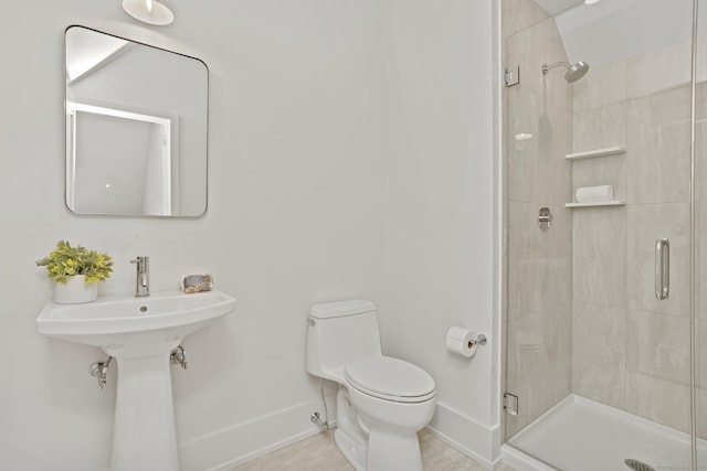 bathroom featuring tile patterned flooring, a shower with shower door, and toilet