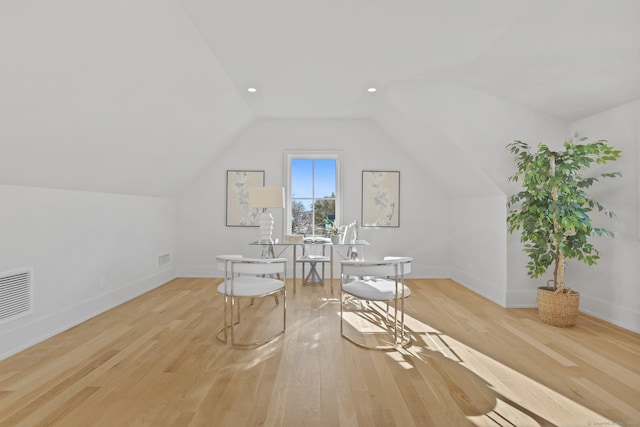 additional living space featuring light hardwood / wood-style flooring and lofted ceiling