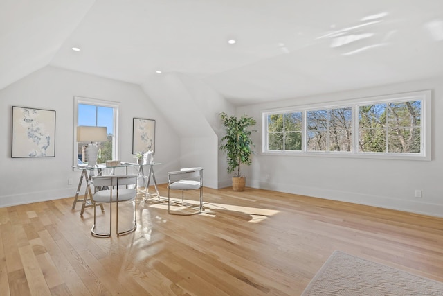 office with a wealth of natural light, light hardwood / wood-style floors, and lofted ceiling