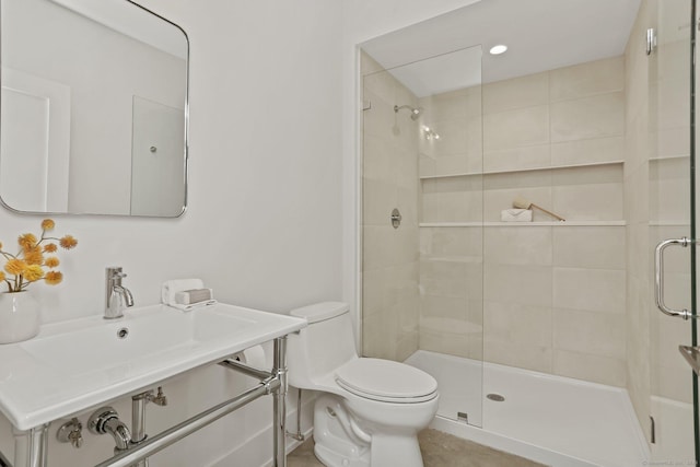 bathroom featuring toilet and an enclosed shower