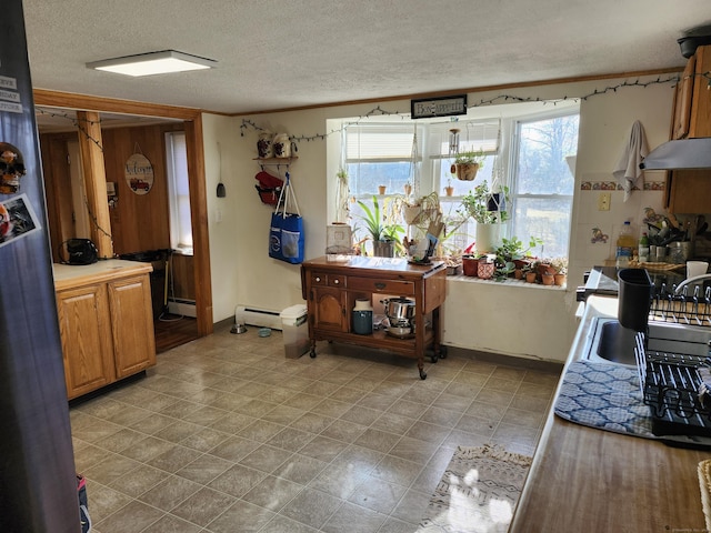 kitchen featuring a textured ceiling and a baseboard heating unit