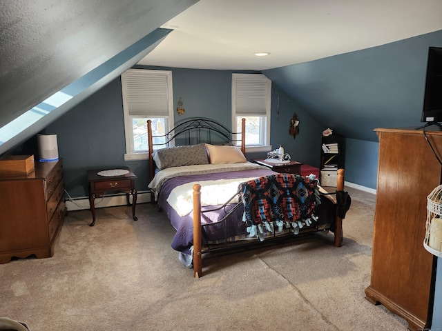 bedroom with light colored carpet, lofted ceiling with skylight, and a baseboard heating unit