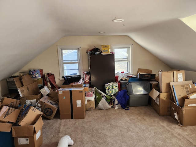 interior space featuring plenty of natural light, light colored carpet, and lofted ceiling