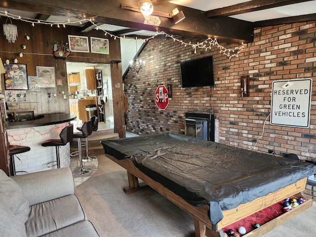 rec room with beam ceiling, a wood stove, billiards, wooden walls, and carpet