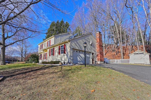 view of front of property with a garage and a front lawn