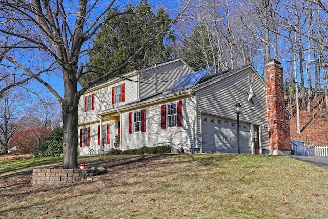 front of property featuring a front yard and a garage