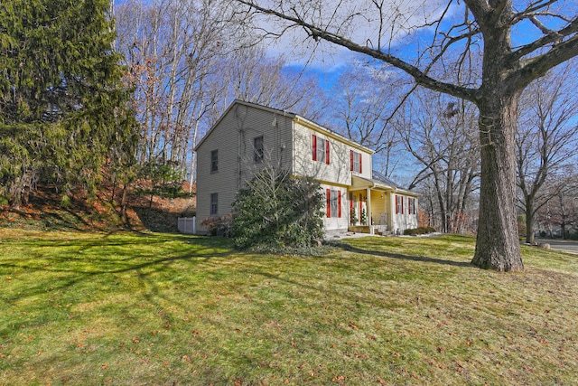 view of front of house featuring covered porch and a front yard