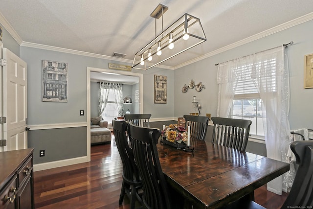 dining area featuring crown molding, dark wood-type flooring, and a textured ceiling