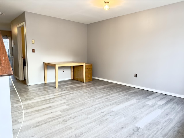 spare room with light hardwood / wood-style flooring