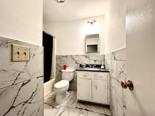 full bathroom featuring vanity, shower / bathtub combination with curtain, tile walls, and toilet