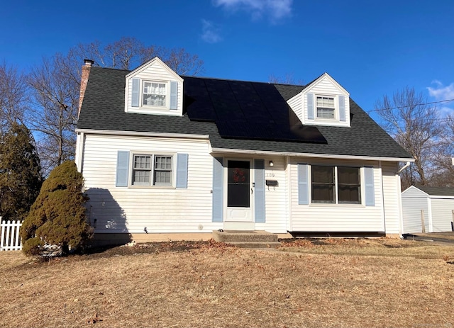 cape cod home featuring a front yard