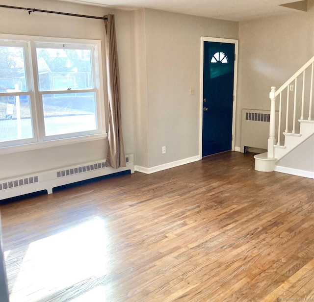 entryway with a baseboard radiator, radiator, and hardwood / wood-style flooring