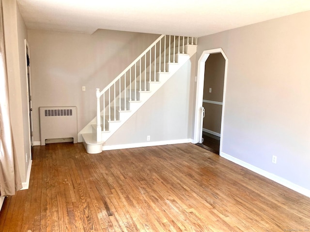 interior space with hardwood / wood-style floors and radiator