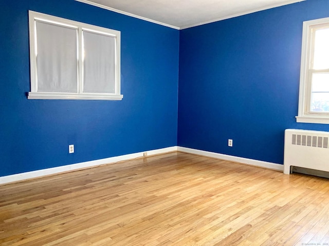 empty room featuring light hardwood / wood-style floors and radiator