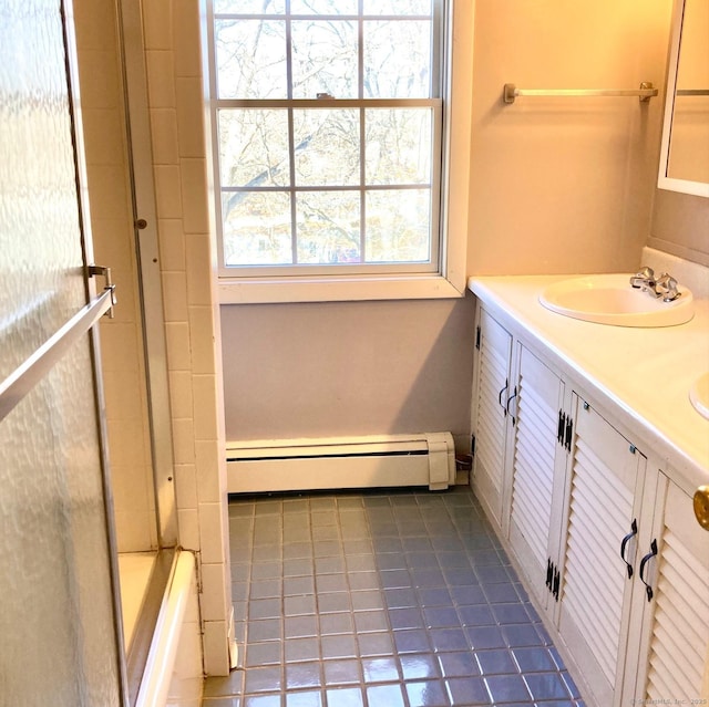 bathroom with  shower combination, vanity, tile patterned floors, and a baseboard heating unit