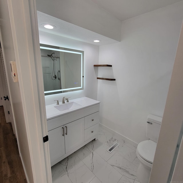 bathroom with toilet and vanity